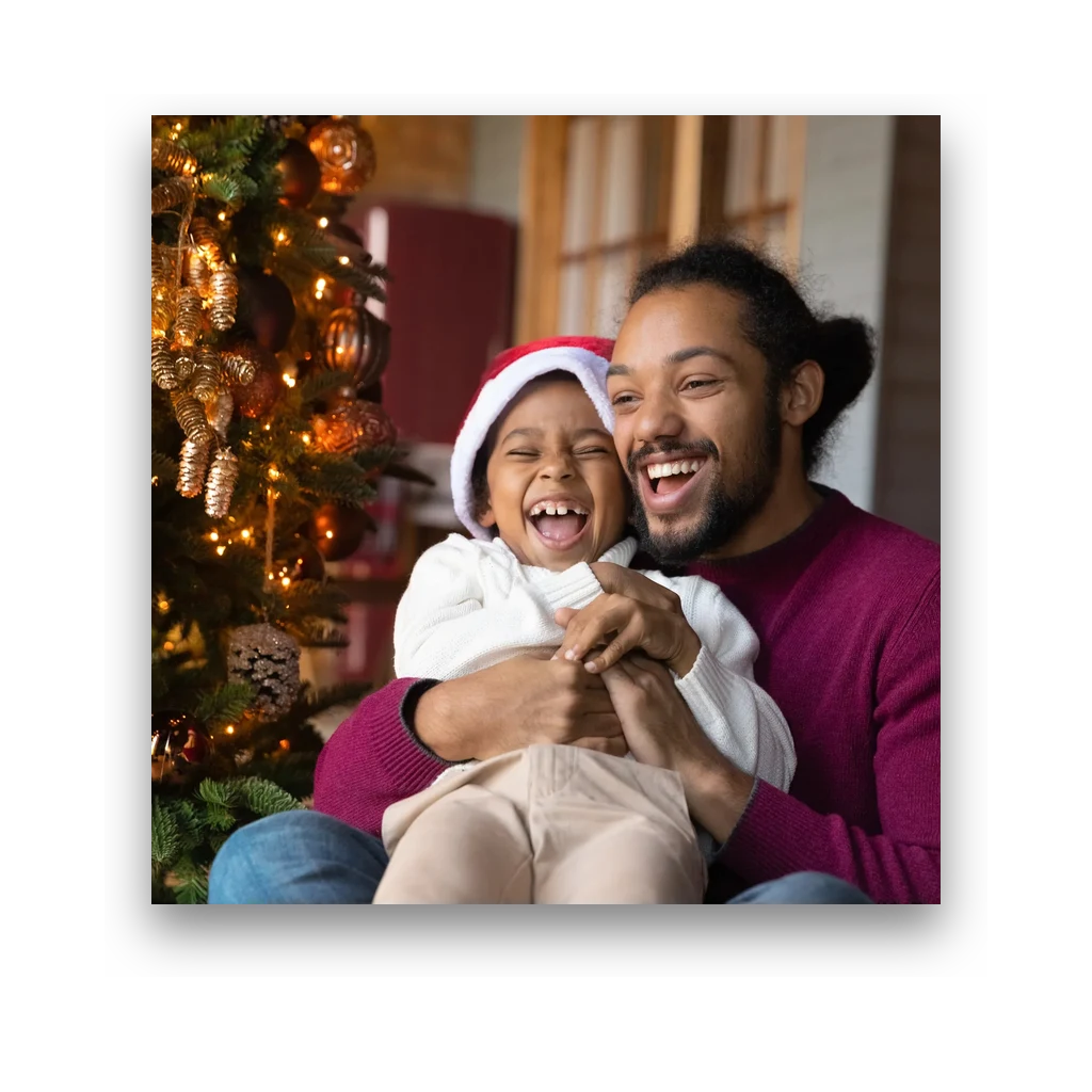 A father and child decorating a Christmas tree, printed as a square photo magnet
